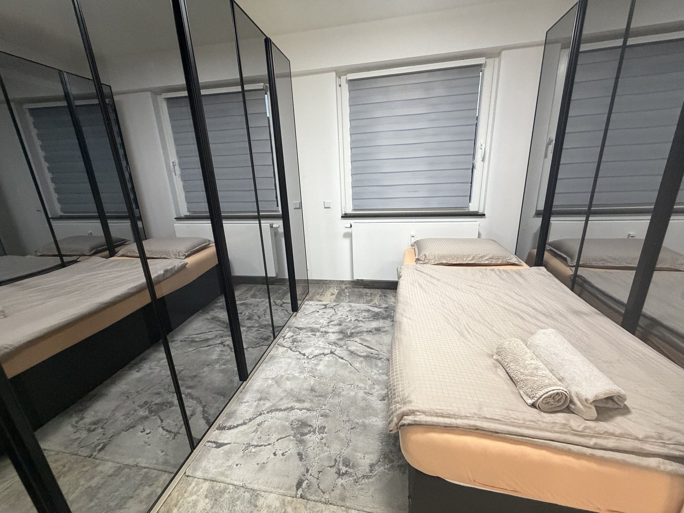 Schlafzimmer mit Einzelbett und Spiegelschrank